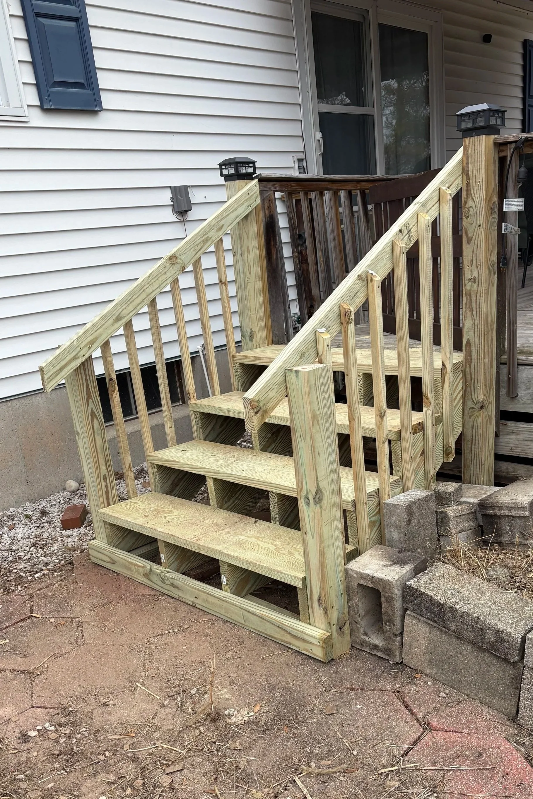 Rebuilt exterior steps and railing completed by Ned's Home & Lawn Maintenance